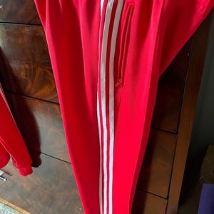 Adidas red track suit.  Small jacket and medium pant.